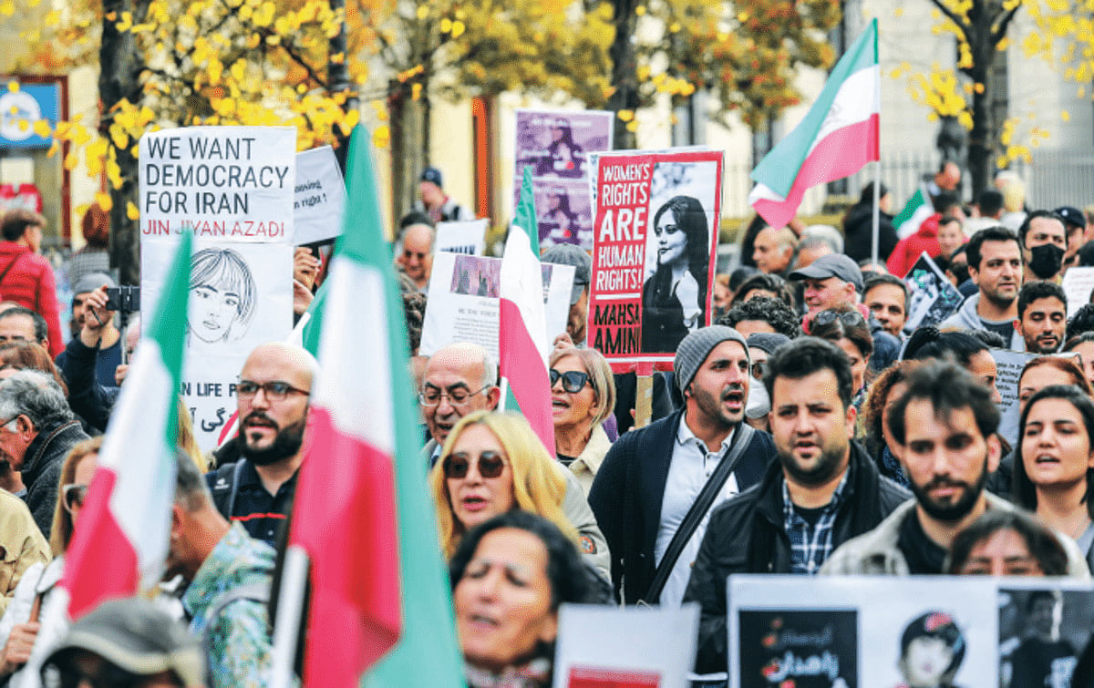 Demonstrators in Berlin, some holding
banners with the image of Mahsa Amini
and Shah-era flags, march in solidarity
with protesters in Iran.