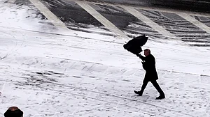 A pedestrian walks in the snow in New York, the United States. (Photo: Xinhua/Li Muzi/IANS)