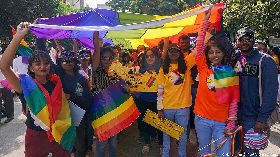 Representative image of Indian youth in a Pride parade with the rainbow flag and a placard saying "Love only knows equality" (photo: National Herald archives)