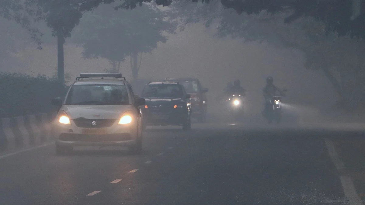 Vehicles ply on fumigated road, in New Delhi. (Photo: IANS)
