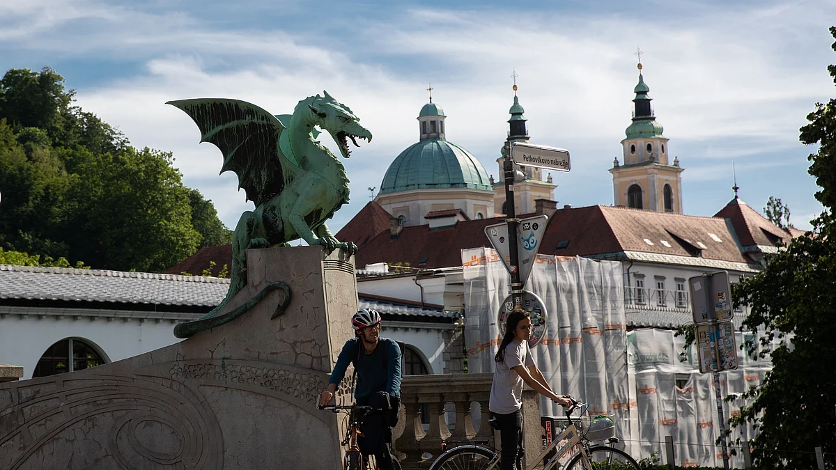 Cyclists pass Dragon Bridge in Ljubljana, Slovenia. (Photo: Xinhua/Peng Lijun/IANS)
