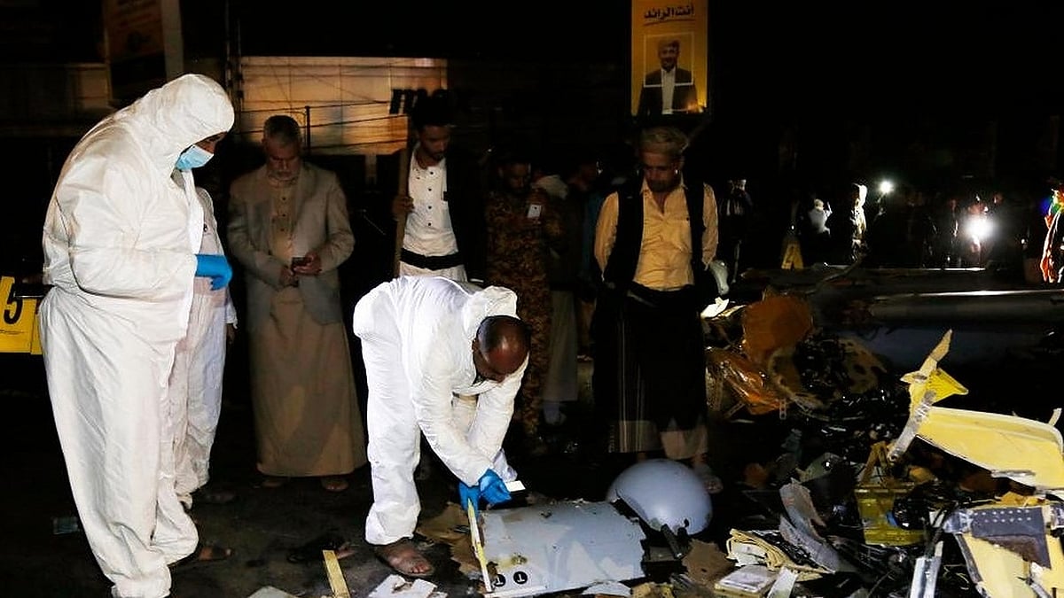 emeni people gather at the site where a drone crashed into a populous neighborhood in Sanaa, Yemen, on May 23, 2022. (Photo by Mohammed Mohammed/Xinhua/IANS)
