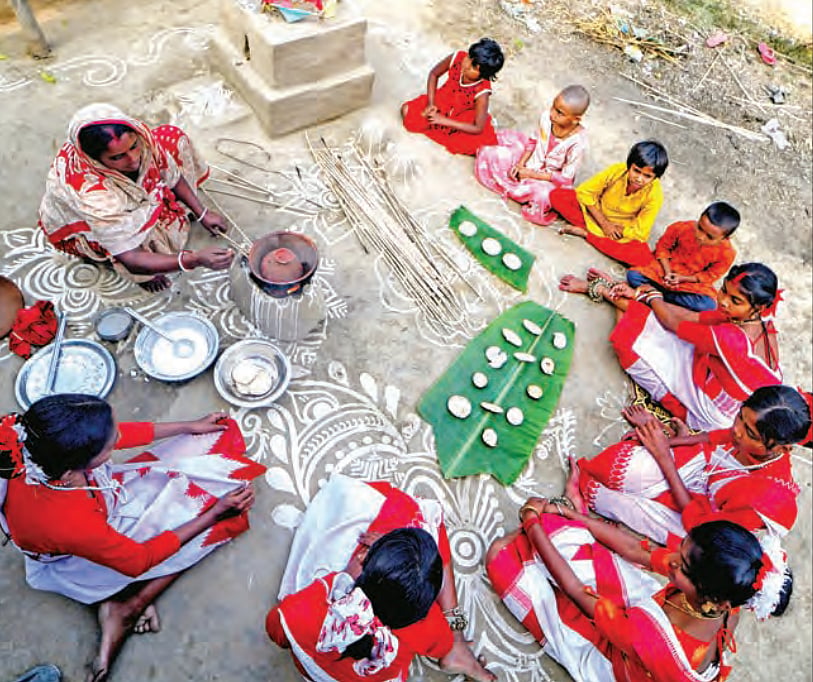 A tribal woman prepares ‘pithe’ on Makar Sankranti in Shantipur, a remote 
village in rural Bengal