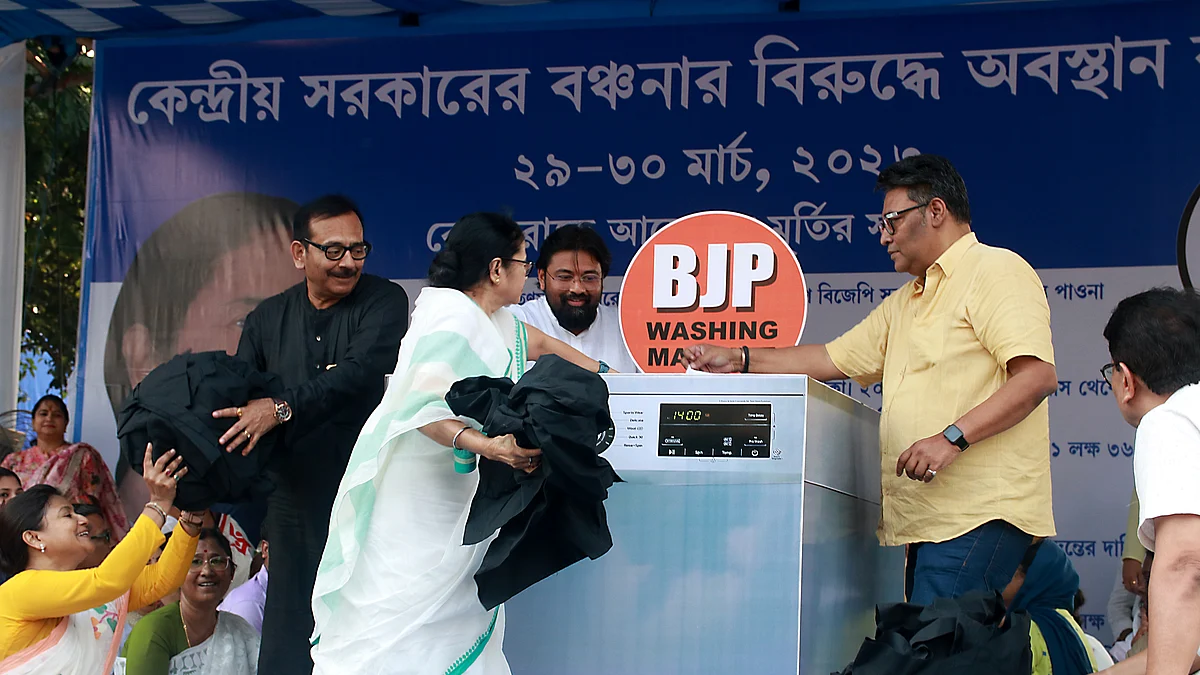 Mamata Banerjee was seen dropping black clothes inside the machine and picking up white ones suggesting the BJP's alleged double standards. (Photo courtesy: Getty)