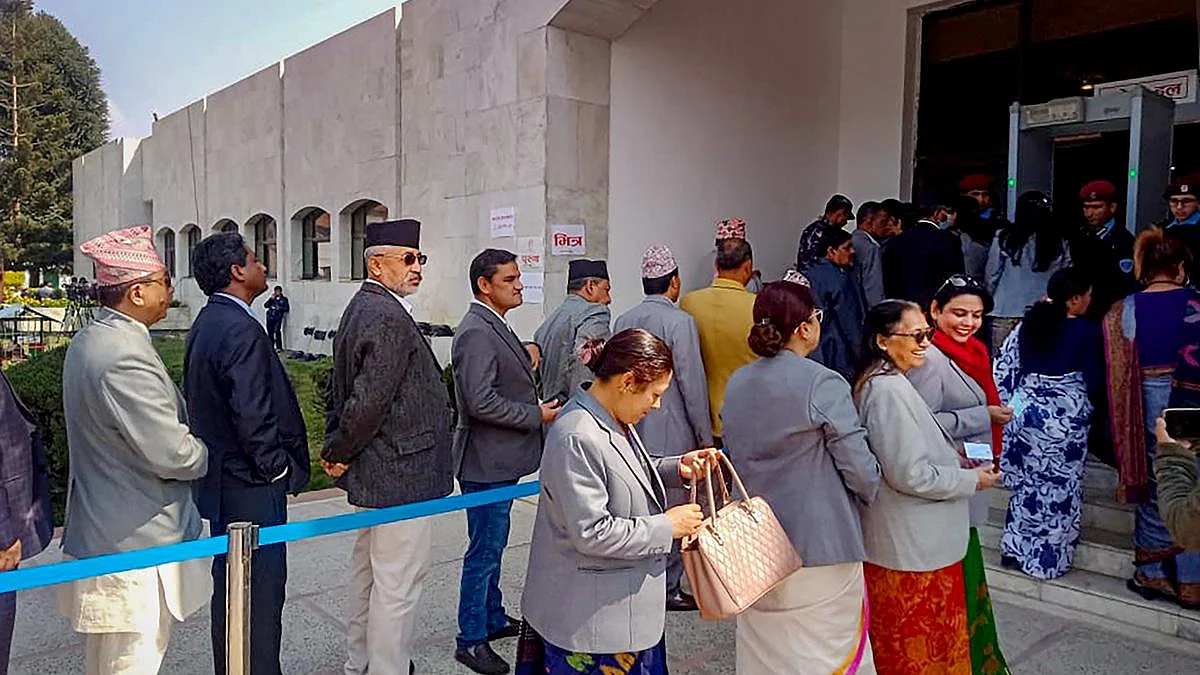 People wait in queues to cast their votes for the election for the President of Nepal, Thursday, March 9, 2023.