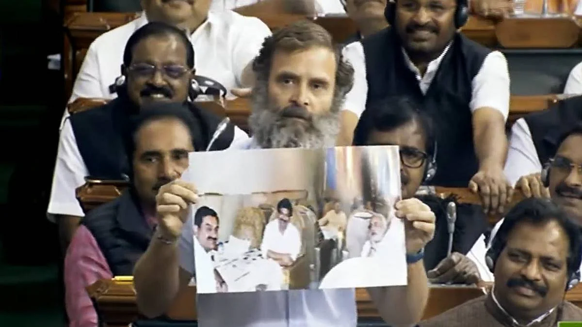 Rahul Gandhi displays a photo of PM Modi with businessman Gautam Adani in the latter's private jet
