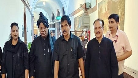 An old picture of Congress president Mallikarjun Kharge and other MPs in black cloths 