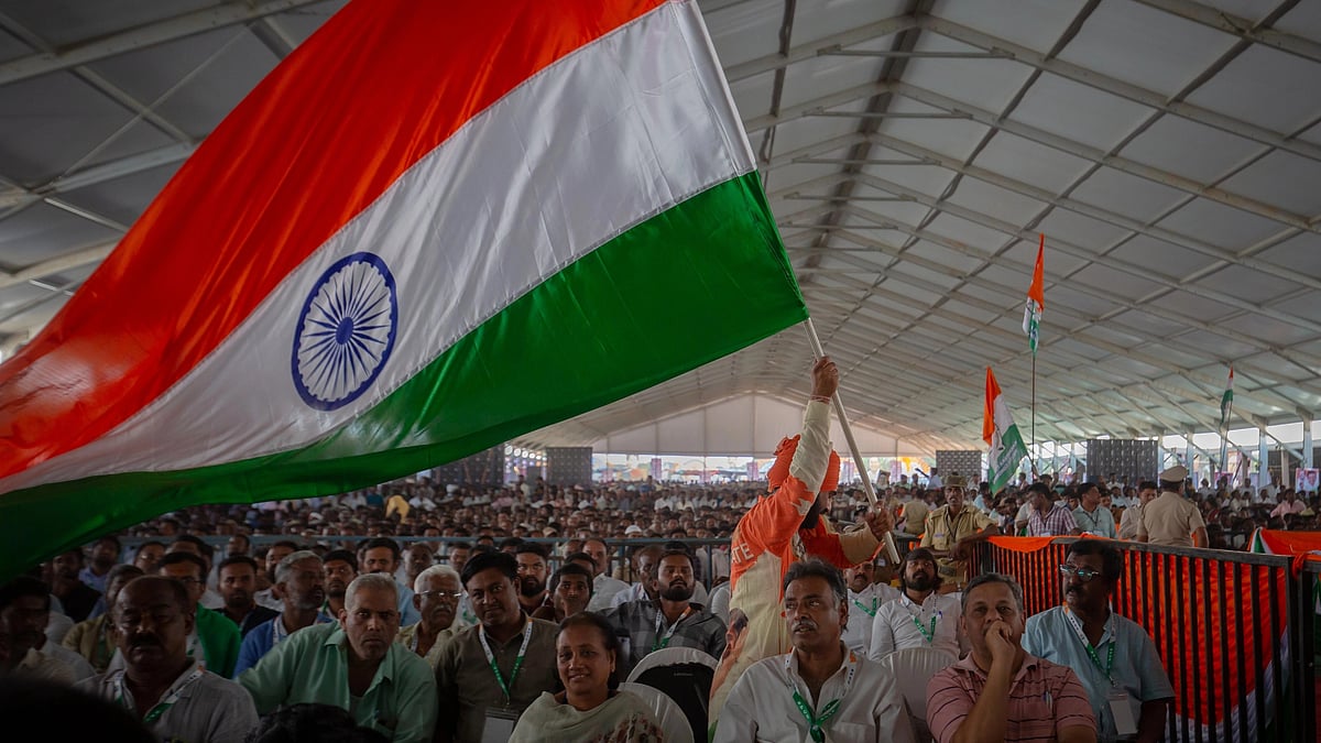 A man waves the Indian national flag as he attends an election rally of the Indian National Congress on April 16, 2023 in Kolar, India ahead of the Karnataka Polls. (Photo: Getty Images)