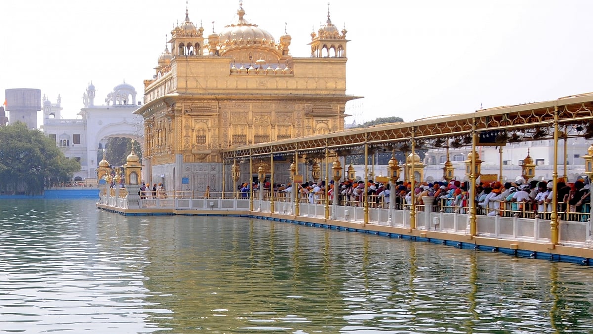 Sikh Devotees wait to offer prayers at the Golden Temple on the occasion of Baisakhi, in Amritsar, on Friday, April 14, 2023. (Photo: Pawan sharma/IANS)