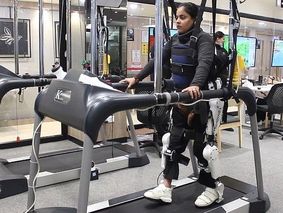 A patients walks on a treadmill with the help of wearable robotic limbs. Photo: IANS