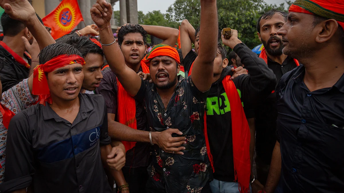 Protestors affiliated with various Hindu organizations wave flags and shout slogans (Photo by Abhishek Chinnappa/Getty Images)