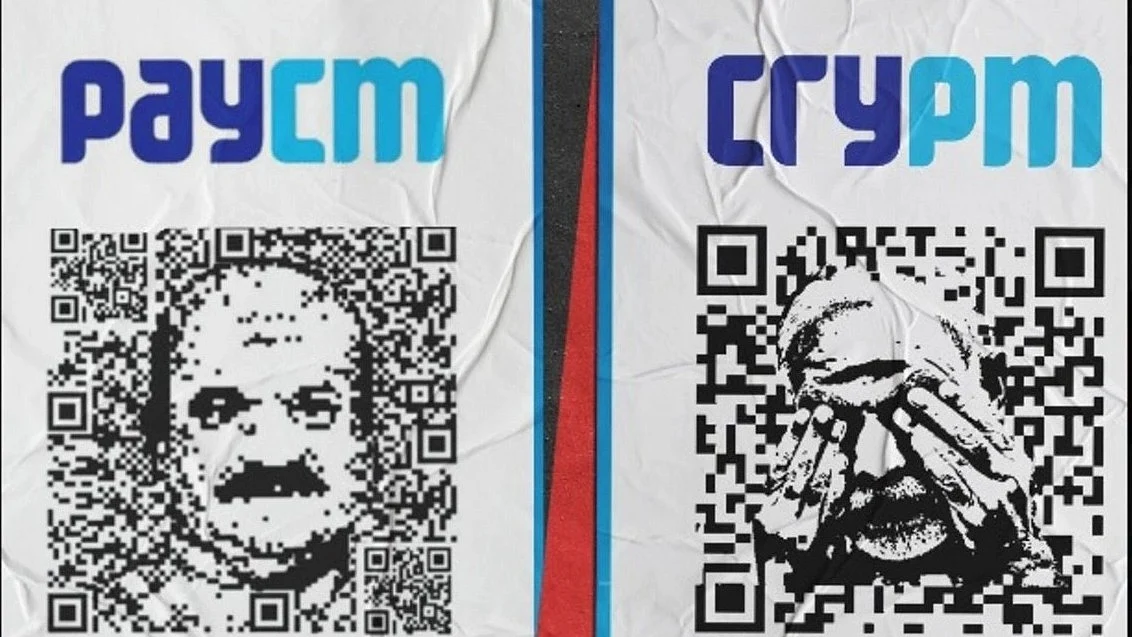 Posters with QR codes and the face of Karnataka CM Bommai and the text "PAYCM" (left), and the face of PM Modi and the text "CRYPM" (right) 