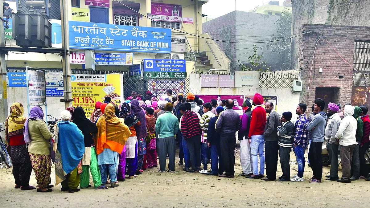 People queue up outside an SBI branch in Punjab’s Amritsar to withdraw some cash on 29 December 2016 following the demonetisation