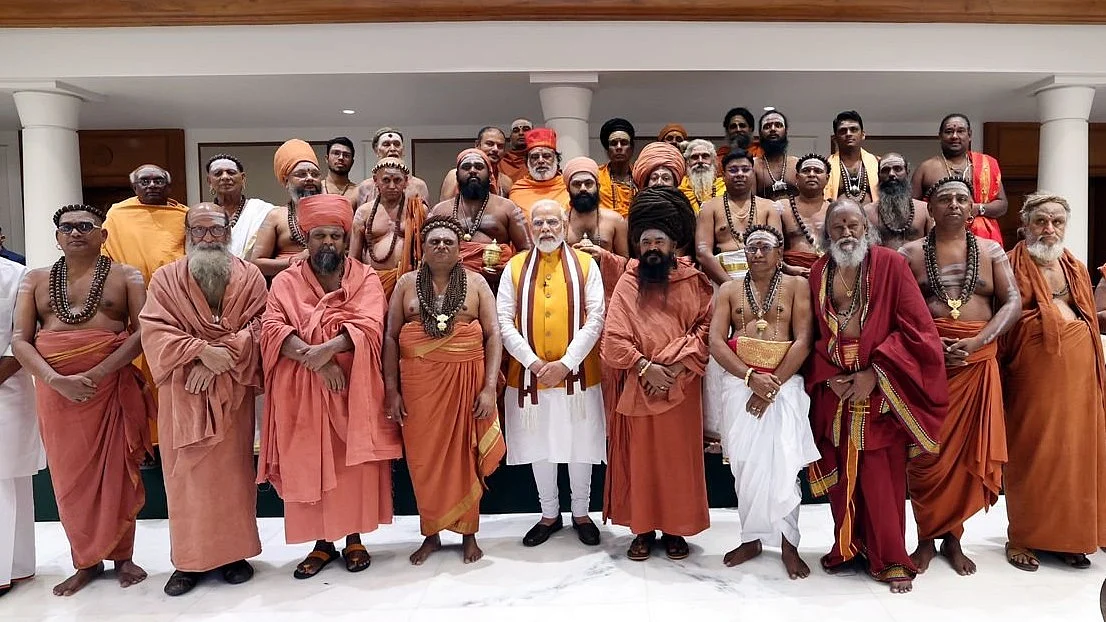 PM Modi at his residence with the adheenams of the mutt from which the much-debated sengol originated (finance minister Nirmala Sitharaman stands to a side, not seen in the frame) (photo courtesy PMO, GOI) 