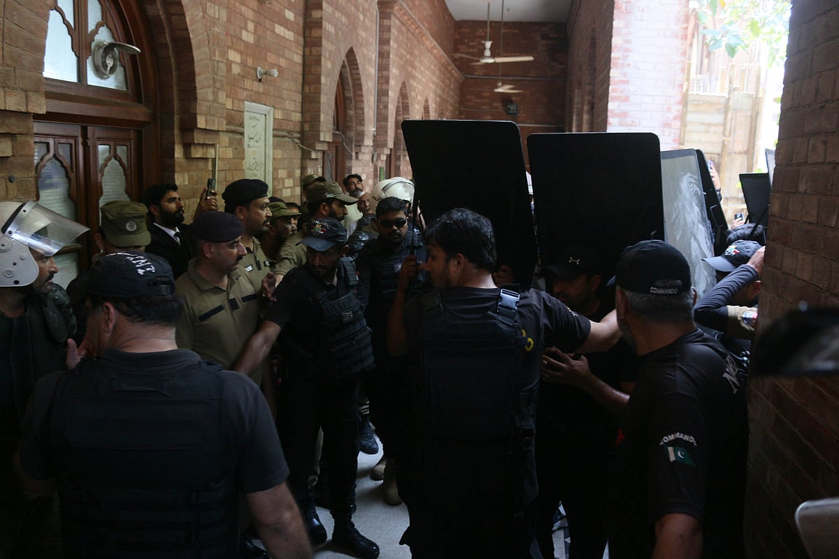 Police take security measures as Former Pakistani Prime Minister and Chairman of Pakistan Tehreek-e-Insaf (PTI) Imran Khan arrives to appear at High Court to seek protective bail in terrorism cases in Lahore. 