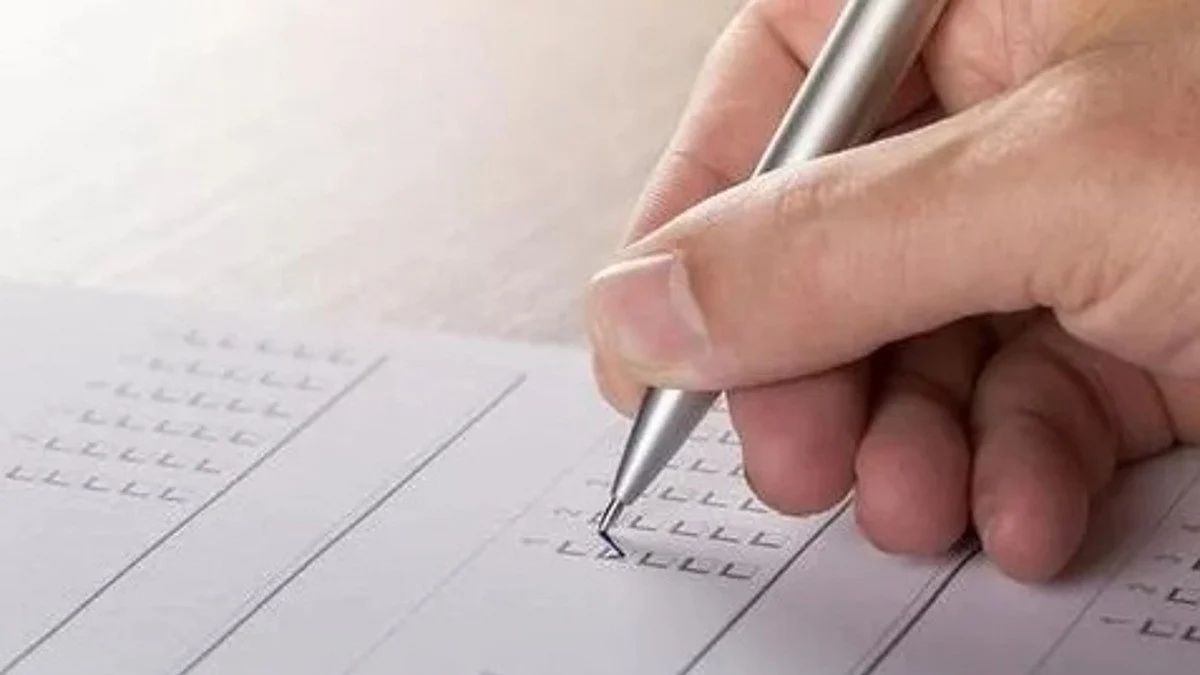 A hand holding a pen (IANS Photo)