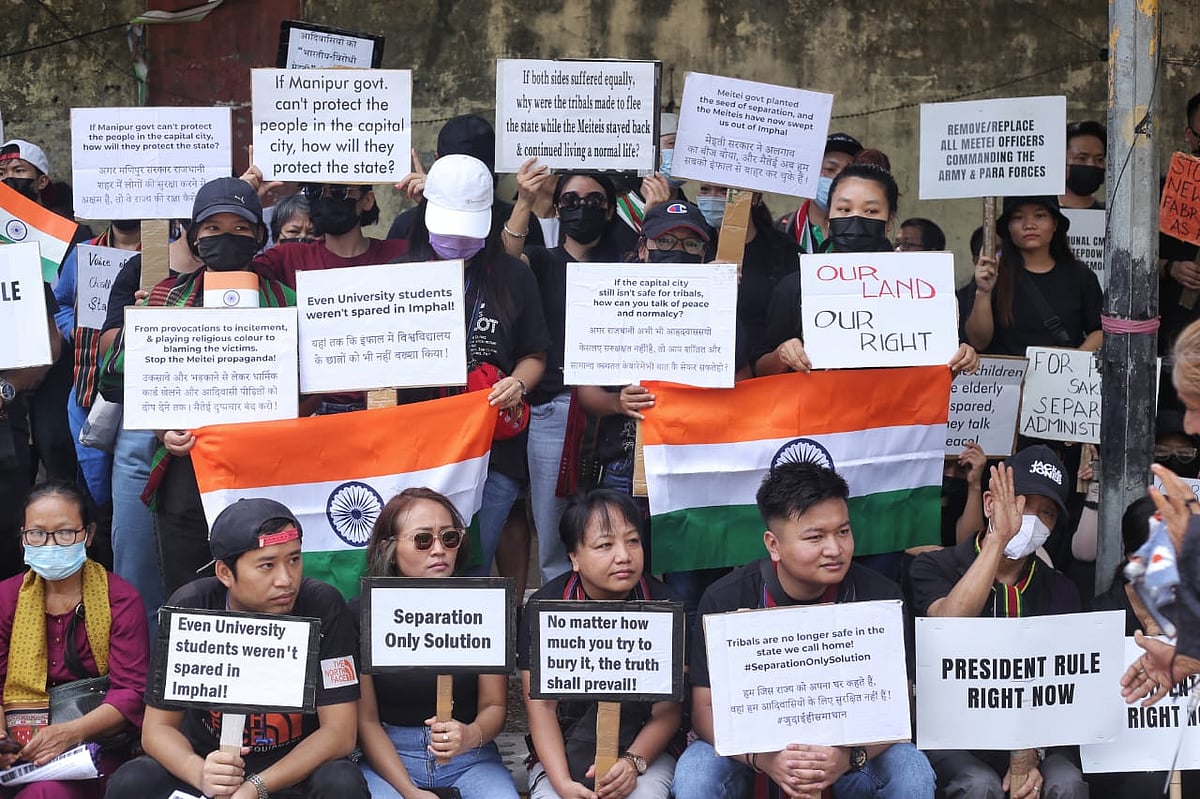 Members of the Kuki tribe hold banners & Indian flags while protesting against the killing of tribals in their home state Manipur, in New Delhi (photo: Vipin/National Herald)