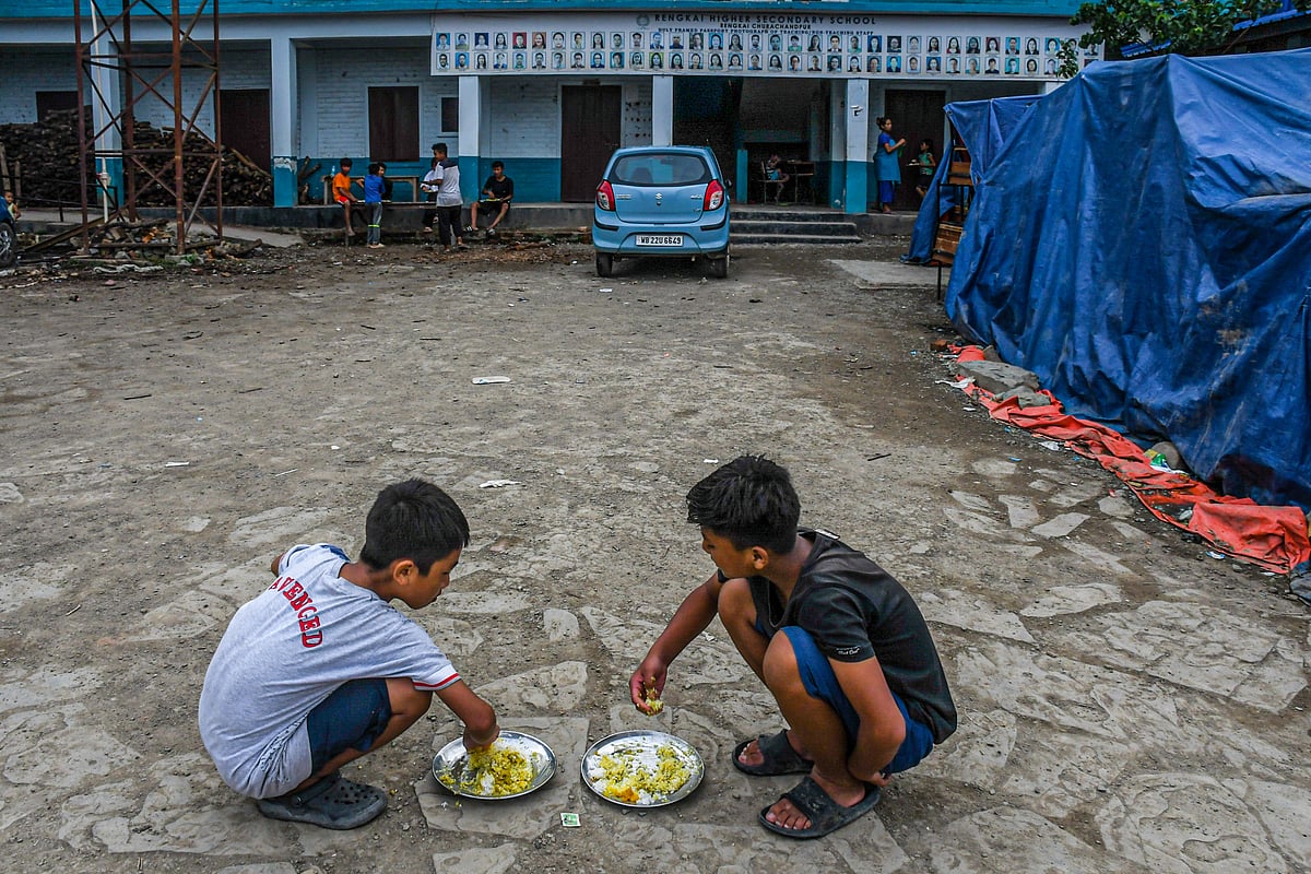 Churachandpur, Manipur: Children take food at a relief camp in Rengkia village (photo: Getty Images)