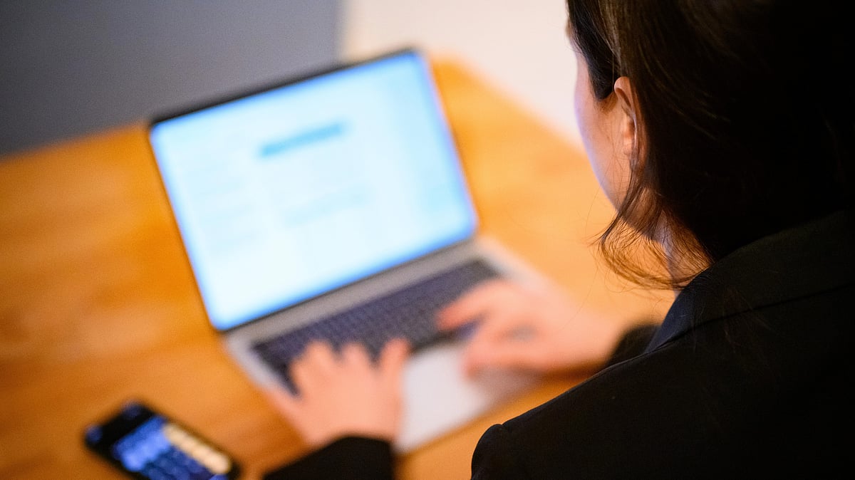 A woman sits at her laptop (photo: Getty Images)