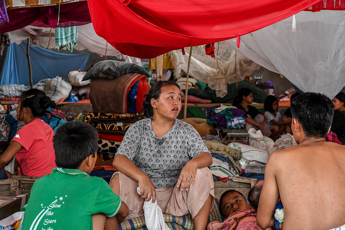 Churachandpur, Manipur: A woman sits with her family in a makeshift relief camp at Saidan village (photo: Getty Images)