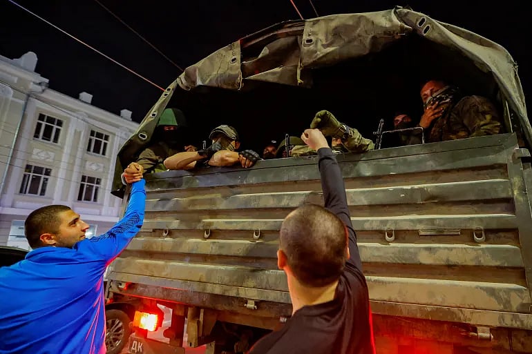 Fist bumps and hand grips for the departing Wagner fighters in Rostov-on-Don (photo courtesy Alexander Ermochenko/Reuters)