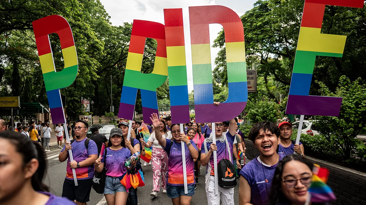 Participants hold placards during the Pride march and festival in Quezon City, Philippines, on Saturday, June 24. (photo: Lisa Marie David/Getty Images)