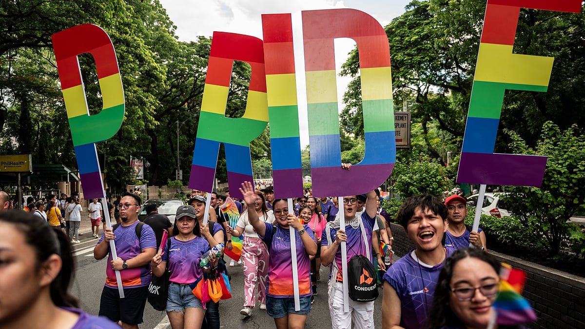 Participants hold placards during the Pride march and festival in Quezon City, Philippines, on Saturday, June 24. (photo: Lisa Marie David/Getty Images)