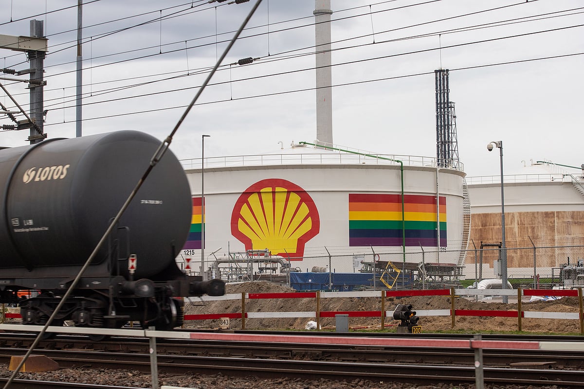 The logo of Shell PLC and a rainbow motif on an oil storage silo at the company's Pernis refinery in Rotterdam, Netherlands. The company has repeatedly been accused of 'greenwashing' and misleading investors by classifying its investments in natural gas as spending on renewable energy. It's corporate policy on the queer community and whether it makes any tangible contribution is unknown.