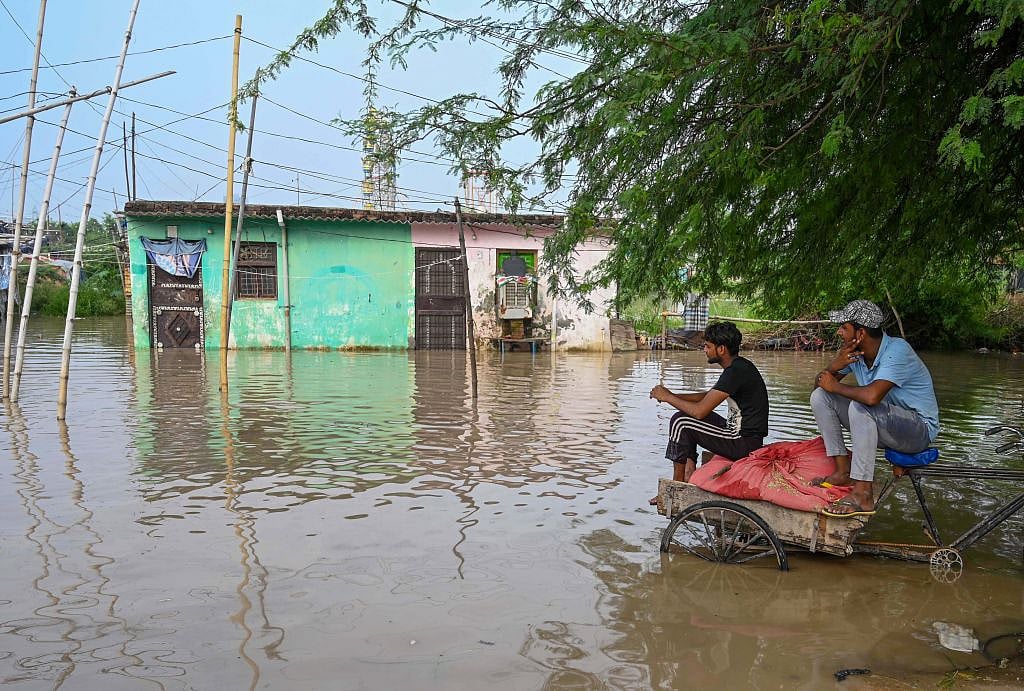 Residents waiting by their residence at Khadda Gaon, Jaitpur Village in Delhi (Photo: Getty Images)