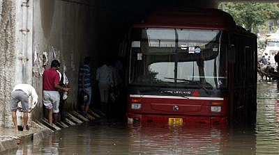 A DTC bus stranded in a flooded underpass in Delhi on Sunday (Photo: IANS)