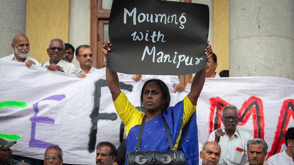 Black poster saying 'Mourning with Manipur' held up by Akkai Padmashali, prominent transgender activist, in a protest in Bengaluru on 21 July 2023 (Photo: Getty Images)