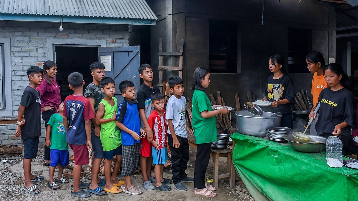 Children wait in queue to receive food at a relief camp in Rengkia village (photo: Biplov Bhuyan/SOPA Images/LightRocket via Getty Images)