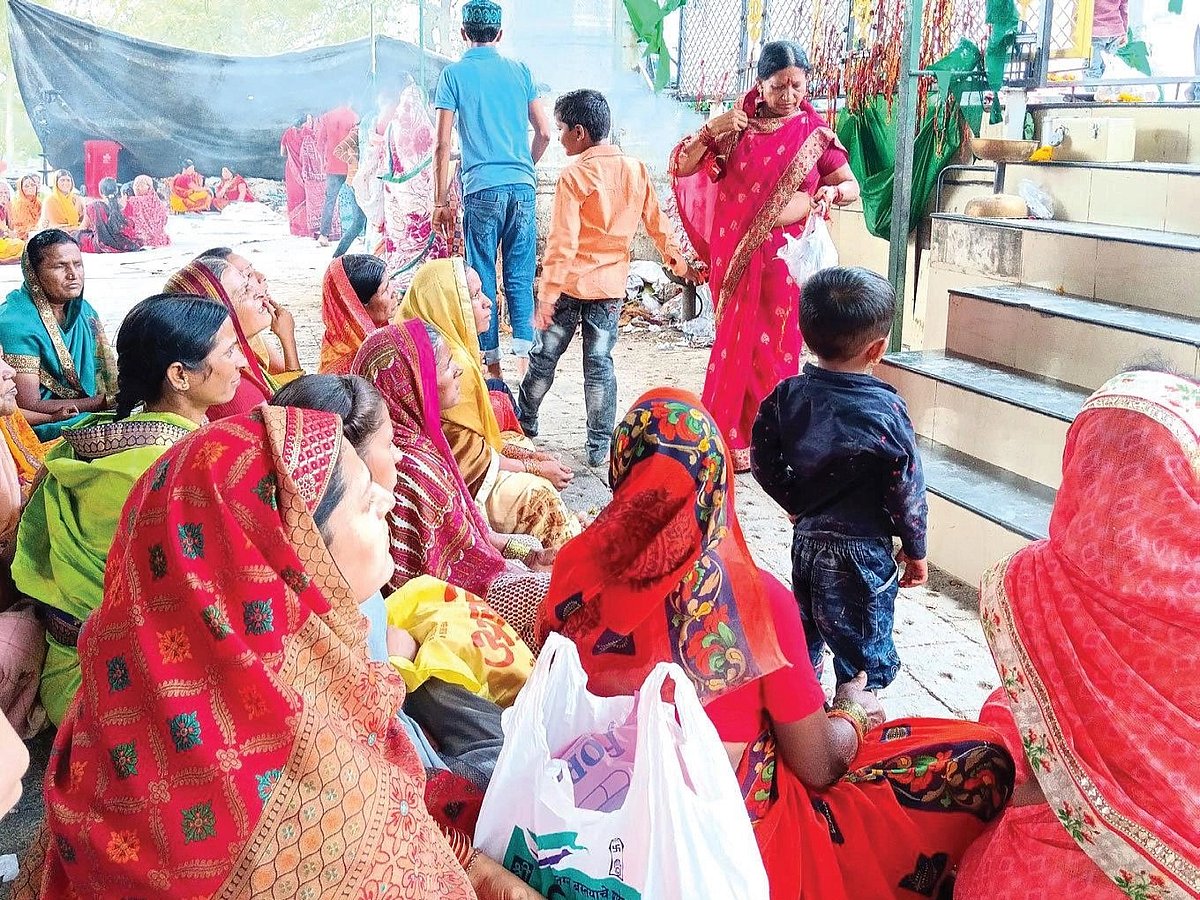 Women sit near the steps as nivad is offered (Photo: Medha Kale)