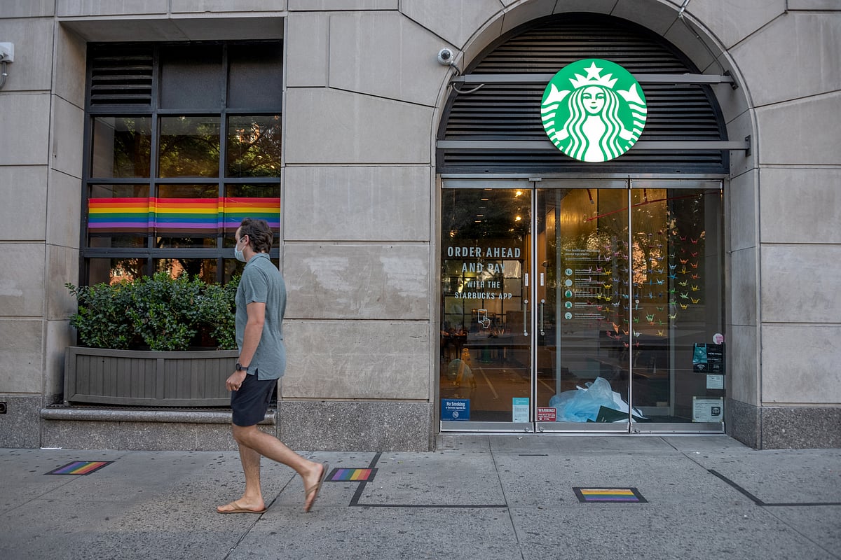 A person walks past a Starbucks store displaying a rainbow flag on June 22, 2020 in New York City. Starbucks has been at the centre of criticism since the beginning of June, 2023, for allegedly banning pride decorations.