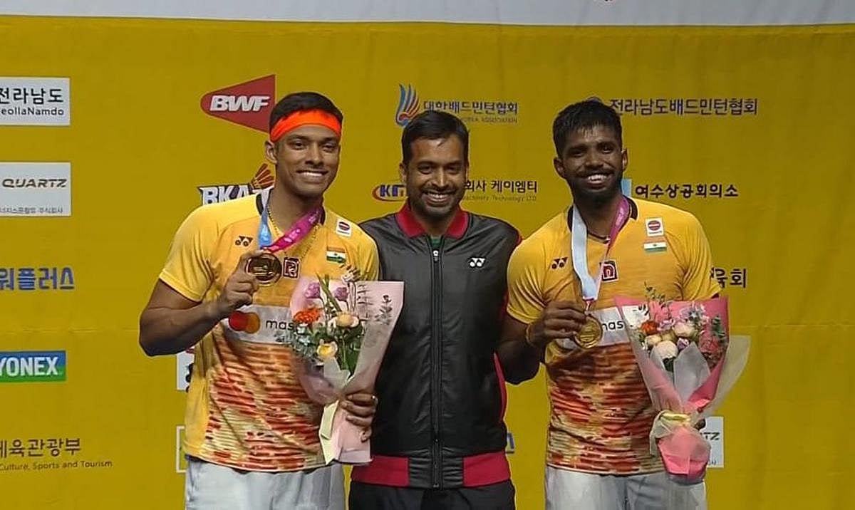 Satwiksairaj Rankireddy and Chirag Shetty with their coach Gopichand after winning the Korea Open title in Yeosu on Sunday, July 23.