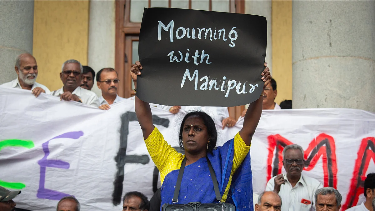 Black poster saying 'Mourning with Manipur' held up by Akkai Padmashali, a transgender activist,  in protest  (Photo: Getty Images)