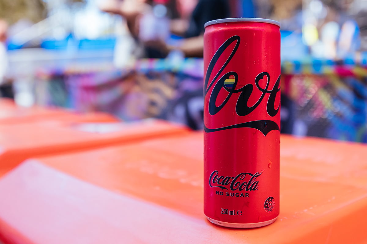 A 'Pride Month' Coco Cola can with the rainbow and 'Love' on it. The company, massively criticised for its contribution to plastic pollution, 'greenwashing', and unfair labour practices, launches pride-themed campaigns annually in June.