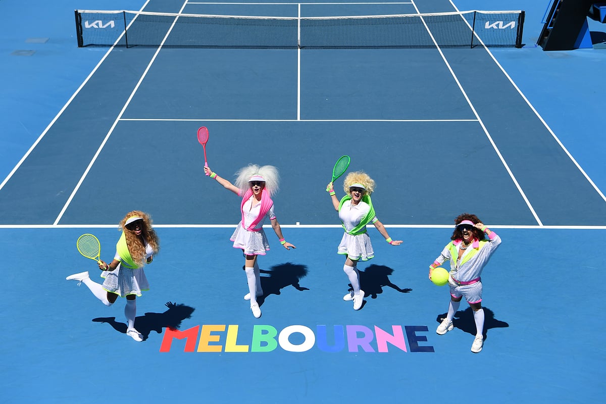 Drag queens stand beside a Melbourne rainbow sign on Pride Day during day 12 of the 2023 Australian Open at Melbourne Park on January 27, 2023 in Melbourne, Australia.