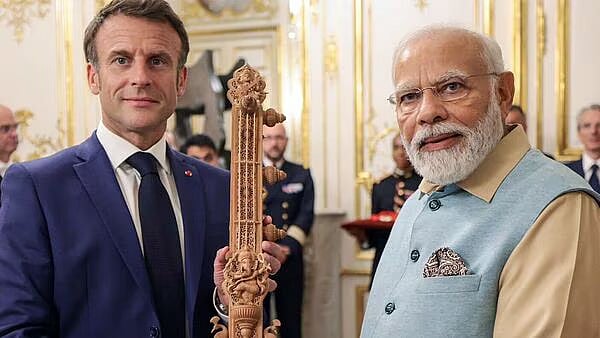 Narendra Modi gifting a sandalwood sitar to French president Emmanuel Macron on his two-day visit to France, on Saturday, July 15 (photo courtesy: @airnewsalerts/Twitter)