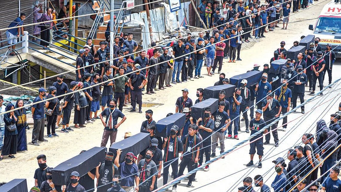 Tribals in Churachandpur take out a silent protest march with dummy coffins to symbolise the dead in the bloody ethnic clashes in Manipur, 20 June 2023 (Getty Images)