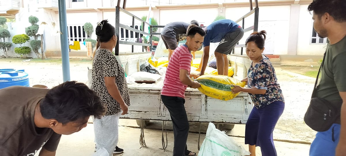Volunteers unload rations at a relief camp for the displaced hill tribes of Manipur (Photo Courtesy: Rural Women Upliftment Society (RWUS) Churachandpur)