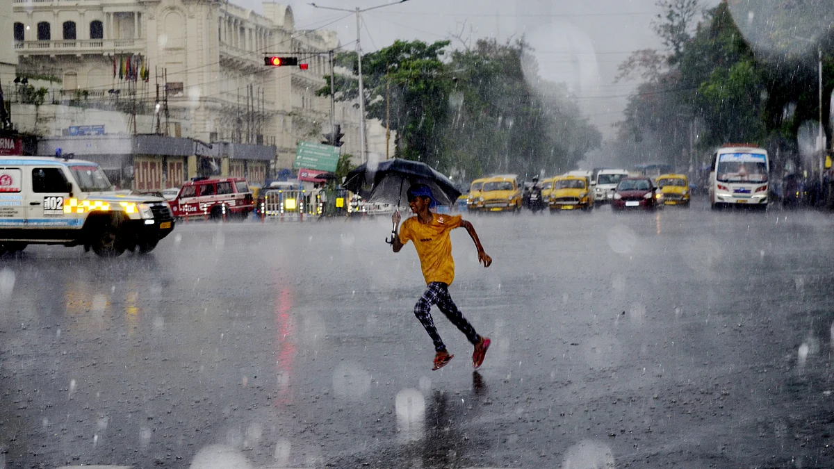 Representative image; A boy runs with an umbrella during heavy rainfall in Kolkata, India, 26 May, 2022. (photo: Getty Images)
