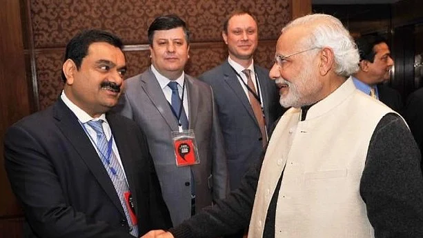 Businessman Gautam Adani (left) has a warm handshake with PM Modi (Photo: Getty Images)