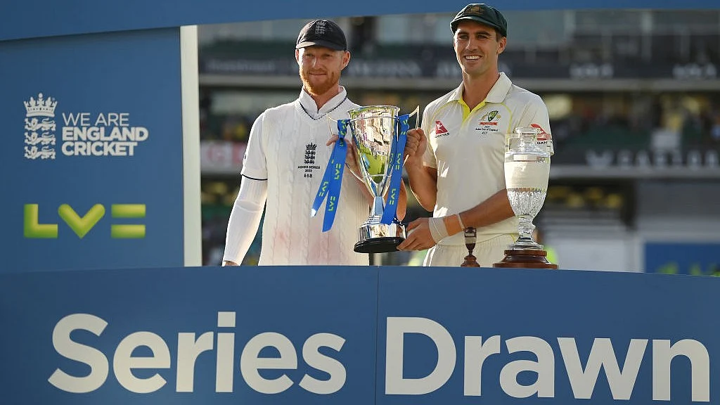 Ben Stokes of England and Pat Cummins of Australia pose with the series trophy after drawing the series after Day Five of Ashes Test Series at the Kia Oval on Monday, July 31, in London. (photo: Getty Images)