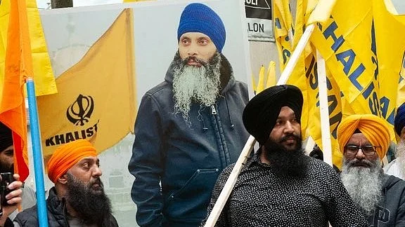 Khalistan supporters holding a poster of slain separatist leader Hardeep Singh Nijjar