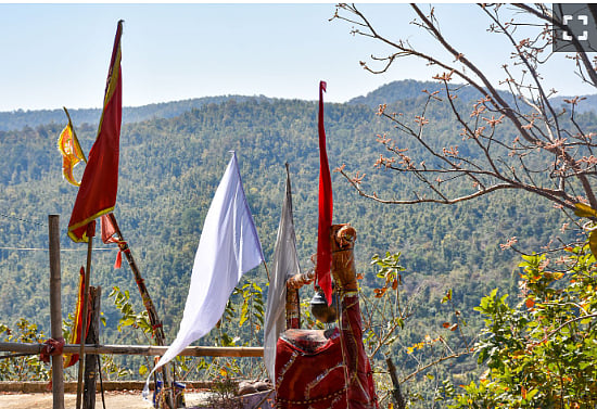 White flags on the mountain belong to the nature worshipping Sarna tribals. The saffron flag represents the Hindus, who also have a temple on the top of the hill Photo: Jacinta Kerketta