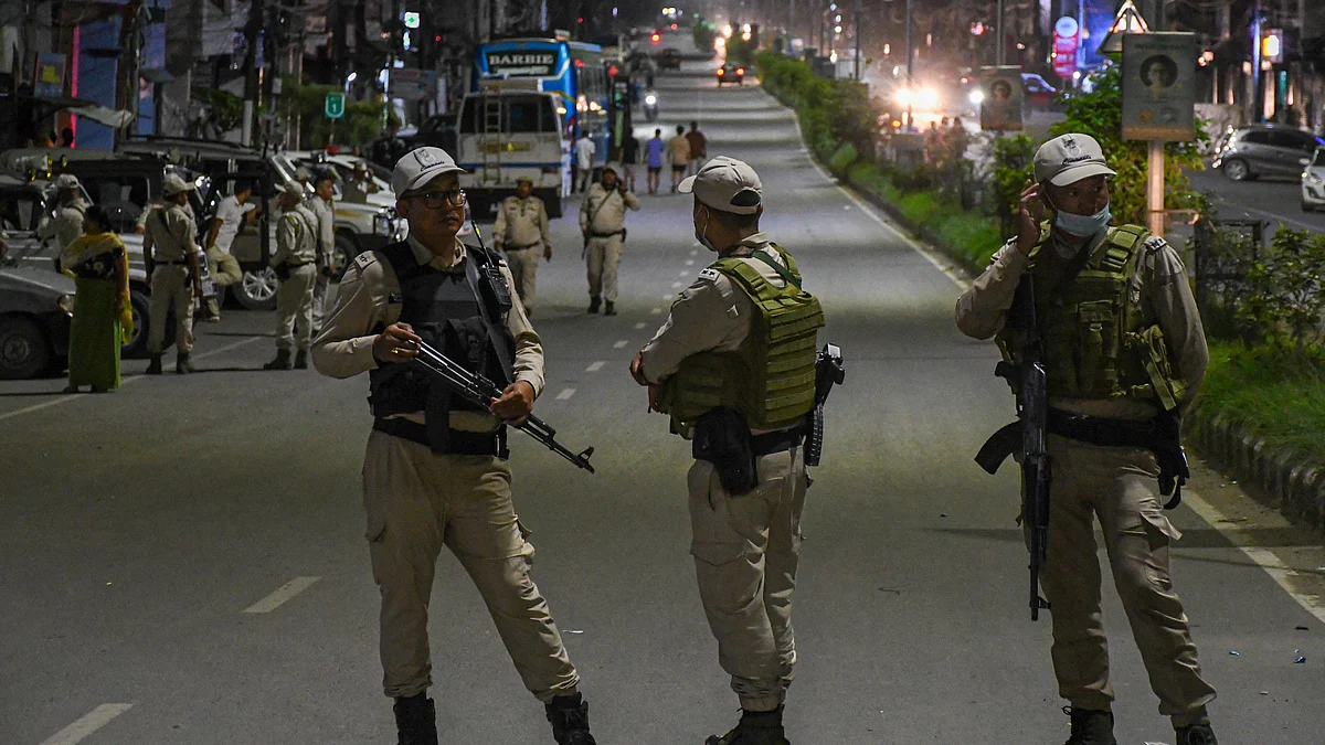 Manipur policemen stand guard during a road blockade (Photo: Getty Images)