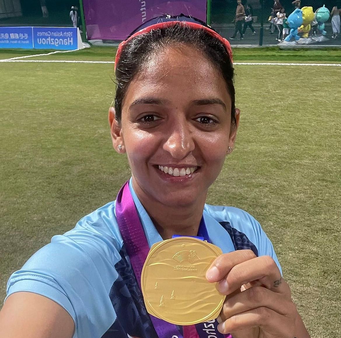 Harmanpreet Kaur poses with her gold medal