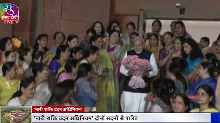 Screengrab of a choreographed event at Parliament House featuring women MPs alongside PM Modi.