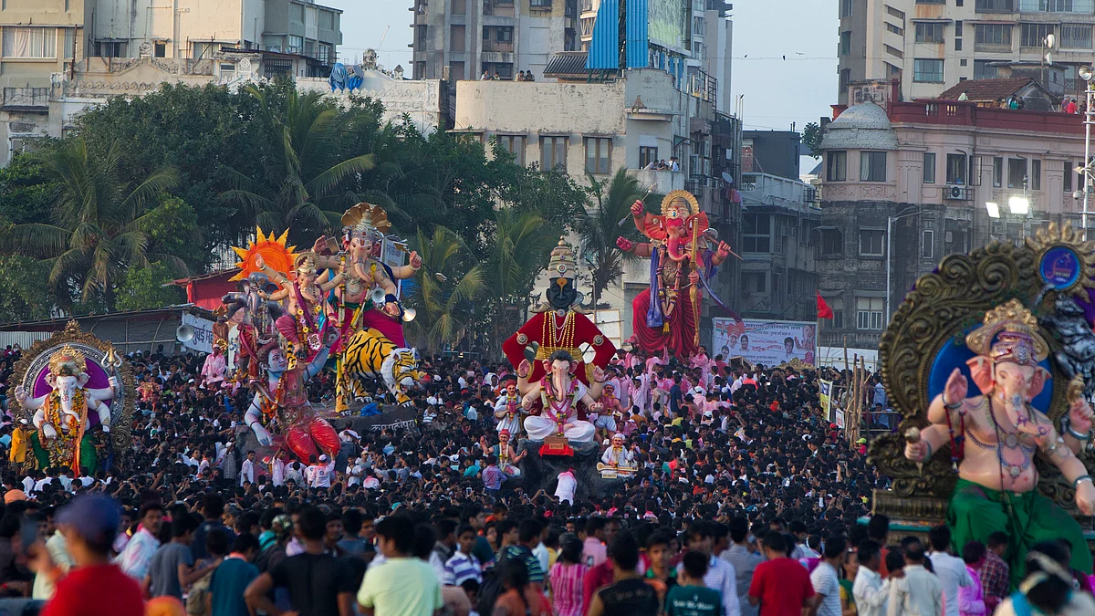 Devotees carrying idols of Hindu Lord Ganesha to immerse in river on the last day of the Ganesh Chaturthi festival at Girgaon Chowpatty in Mumbai. (photo: Satish Bate/Hindustan Times via Getty Images)